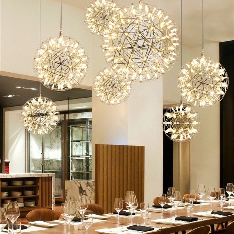 Diverse lampade a sospensione a forma di palla da fuoco sopra la sala da pranzo del ristorante.