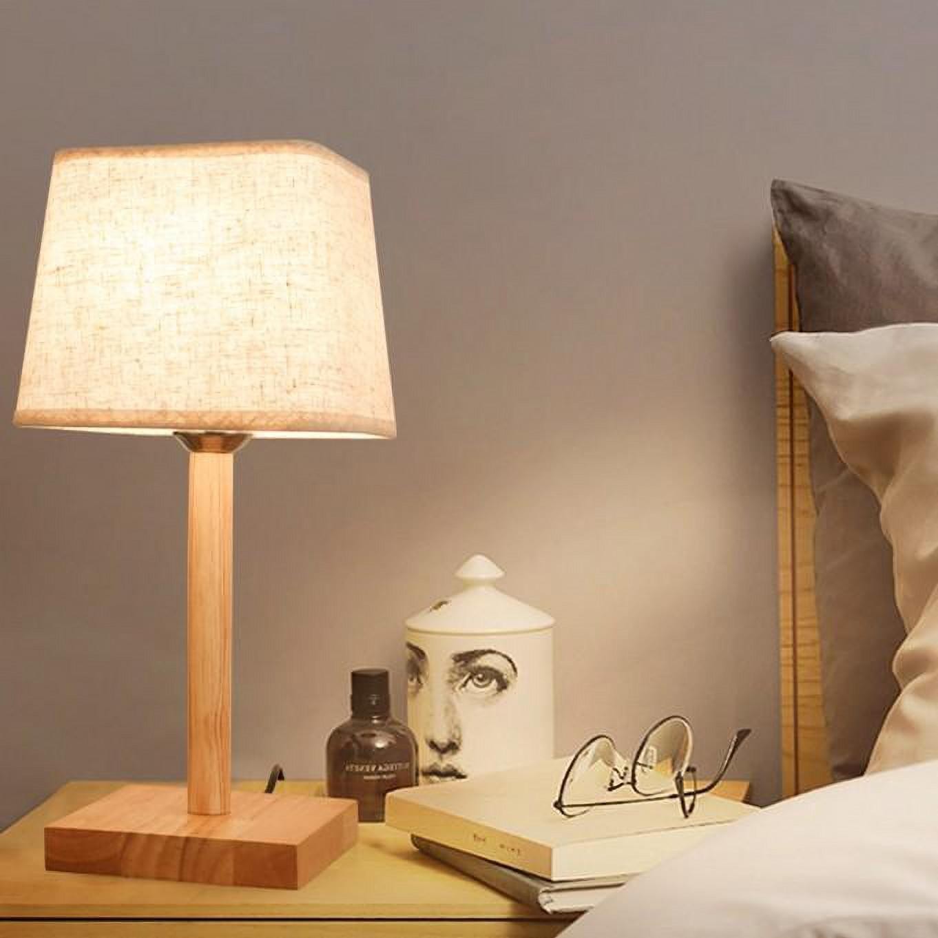Rectangular base wooden lamp on nightstand with books
