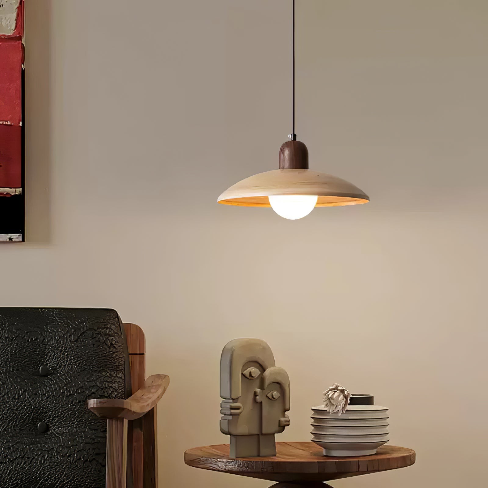 Pendant lamp in a lounge scene above a side table and chair