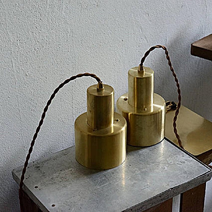 Two Drop Cap Pendant Lights styled on a table