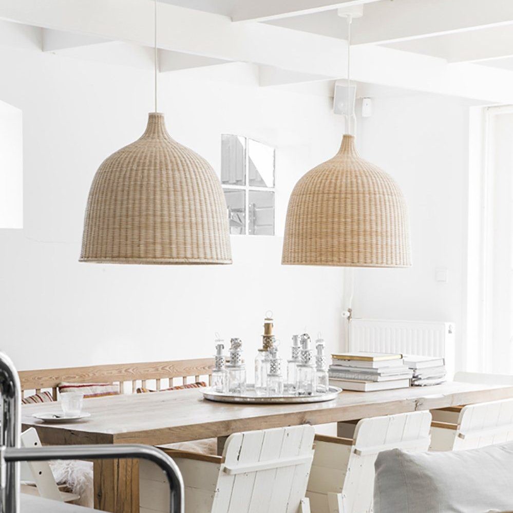 Two rattan pendant lights above a dining table