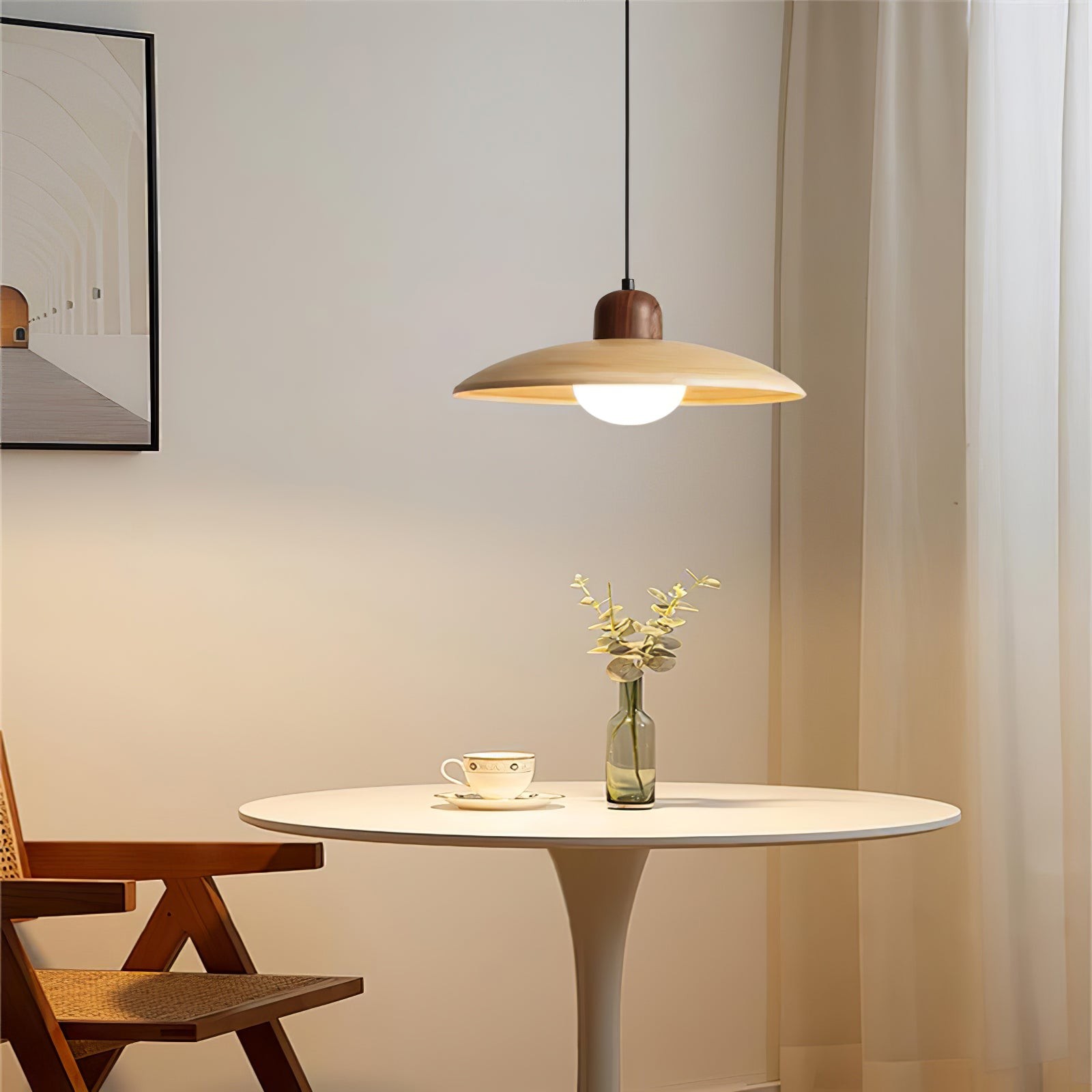 Pendant lamp above a round table in a simple room