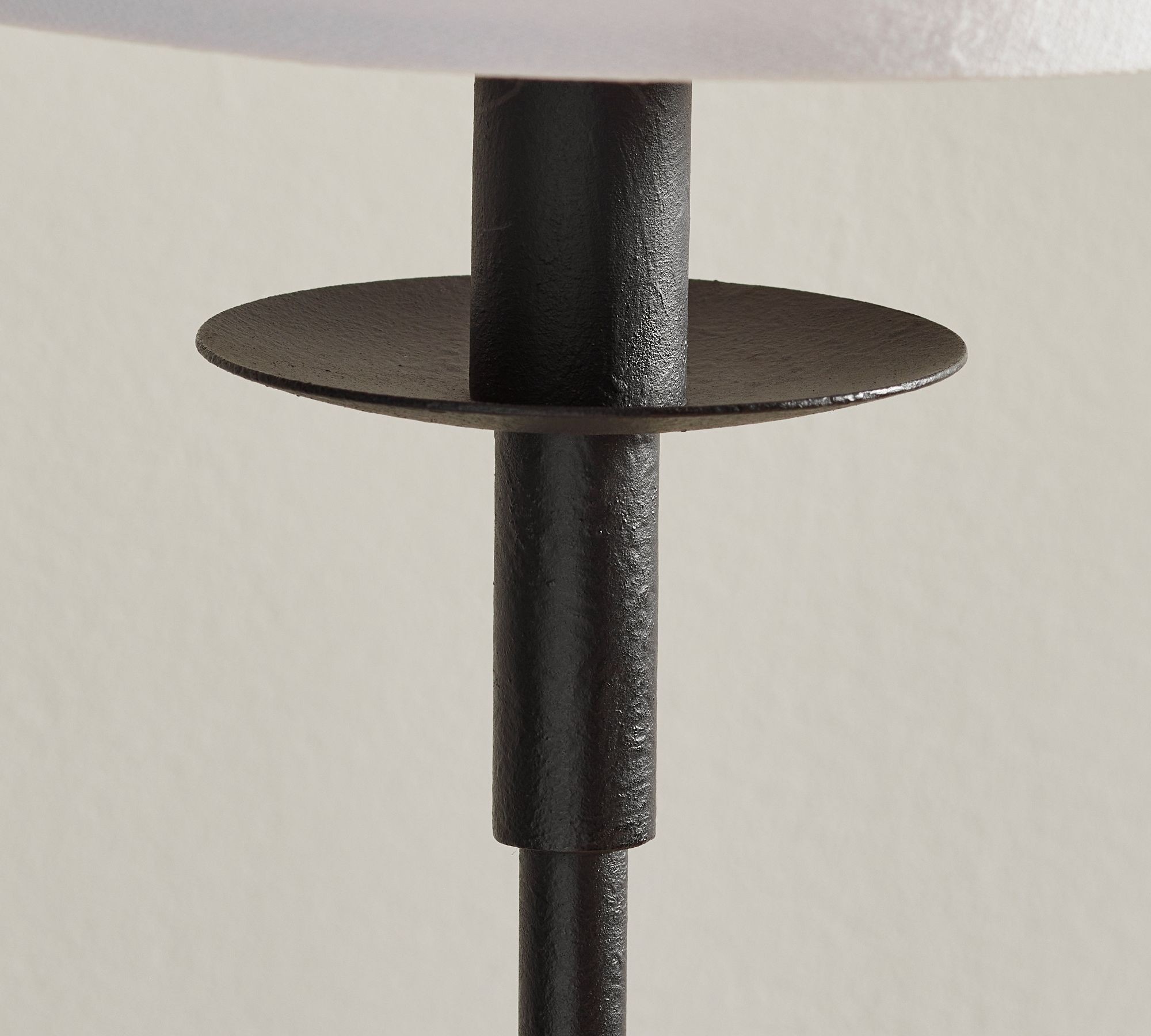 Close-up of the black metal pole and circular accent plate