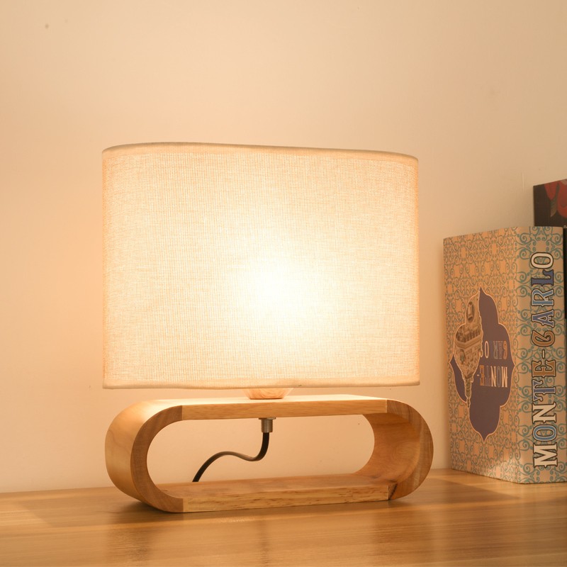 Oval base wooden table lamp in warm room light