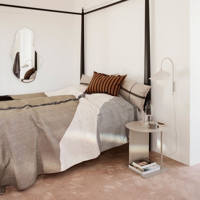 Cashmere wall lamp mounted beside a bed