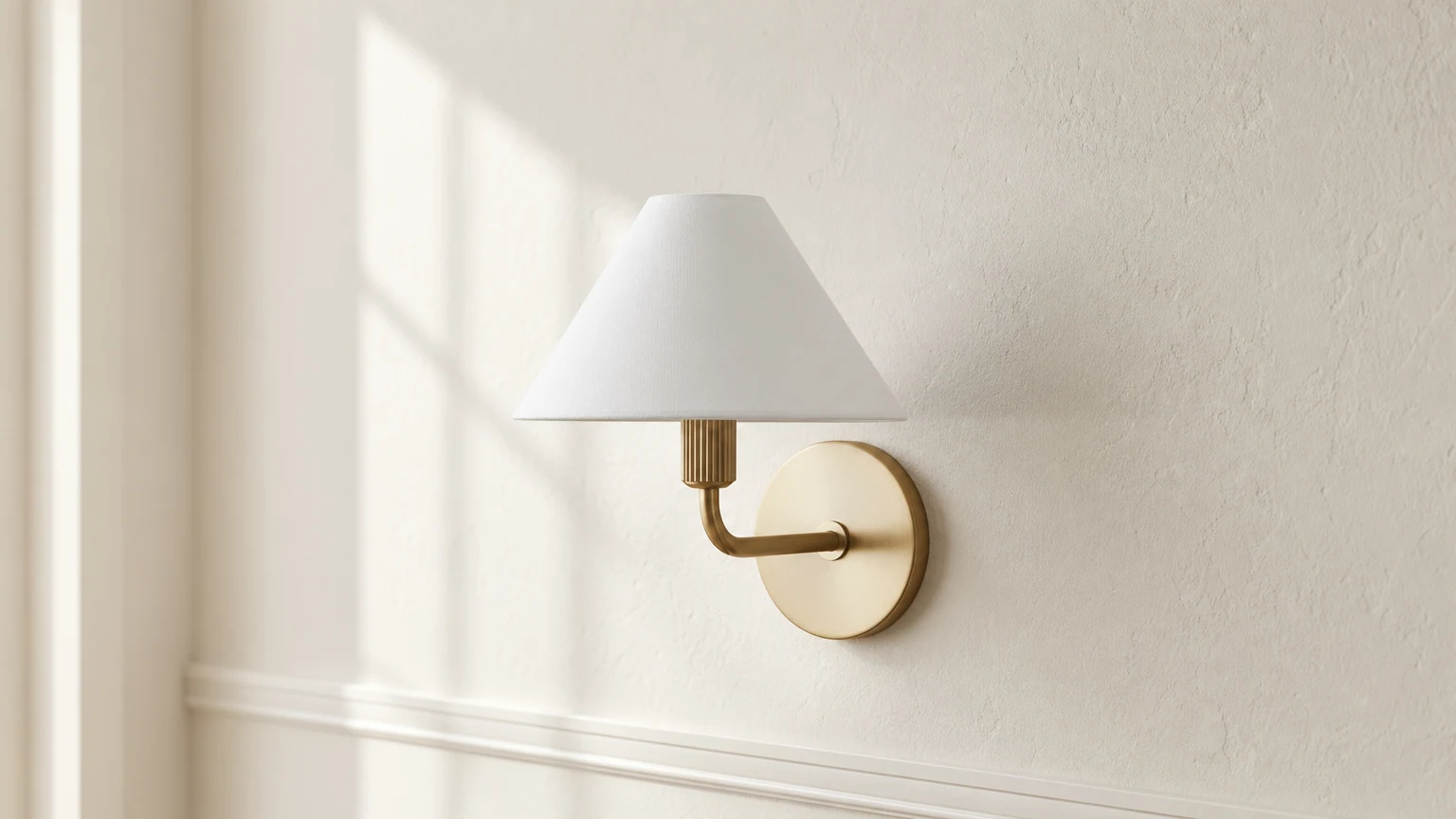 Aplique de pared Diora de latón instalado en un ambiente interior cálido.
