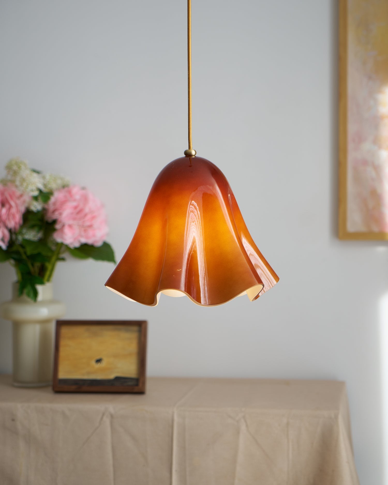 Amber French Skirt Pendant Lamp above a table with flowers