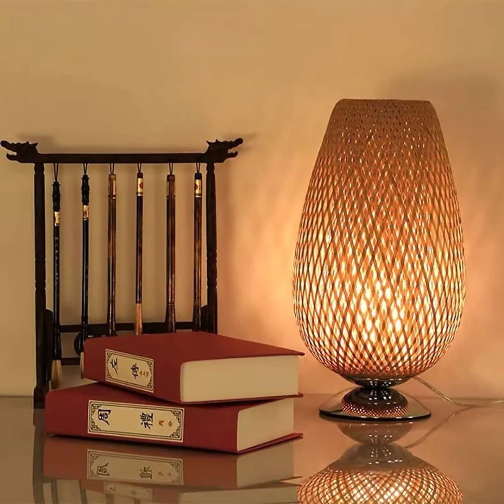 Bamboo table lamp beside books and a small screen