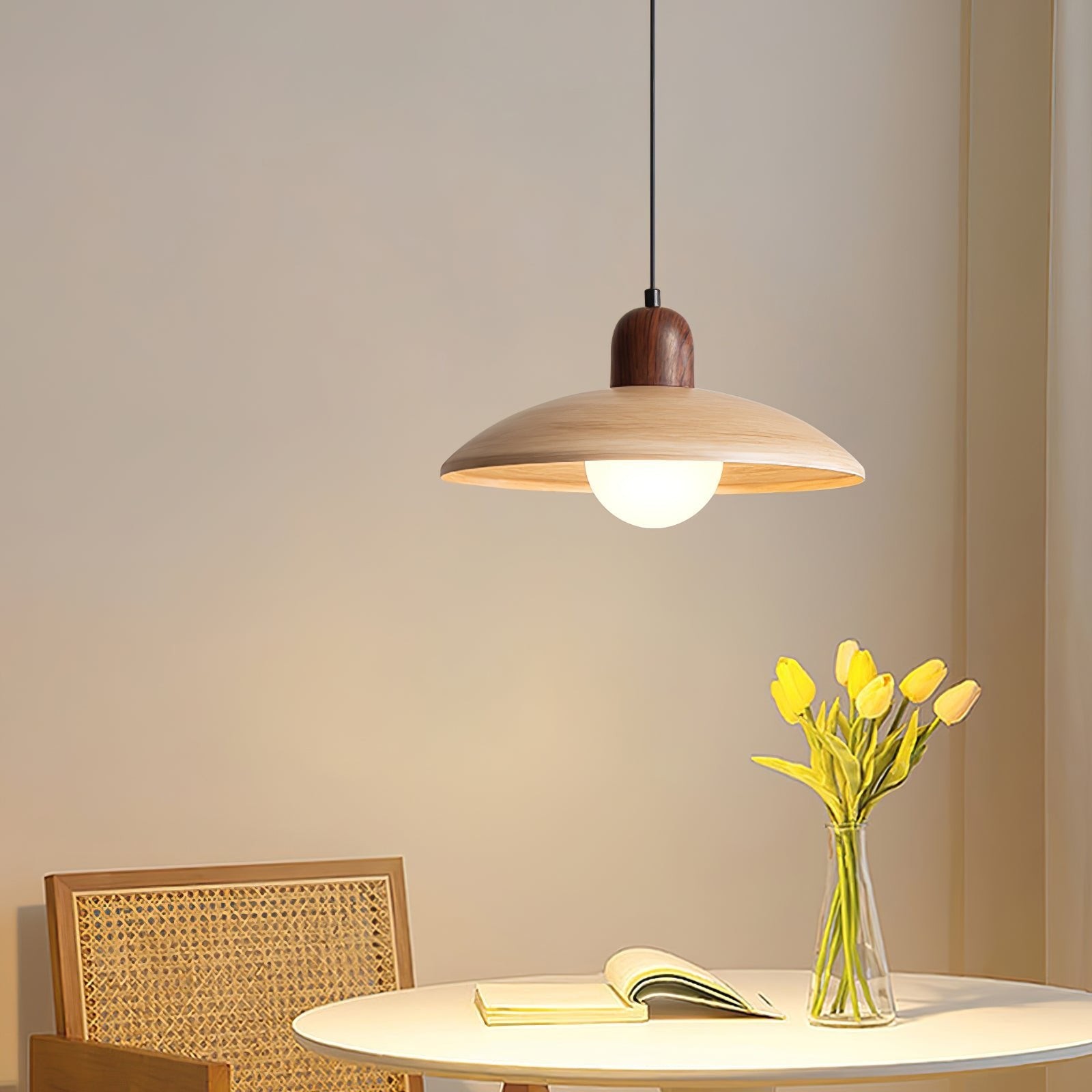 Pendant lamp over a small round table in a warm interior