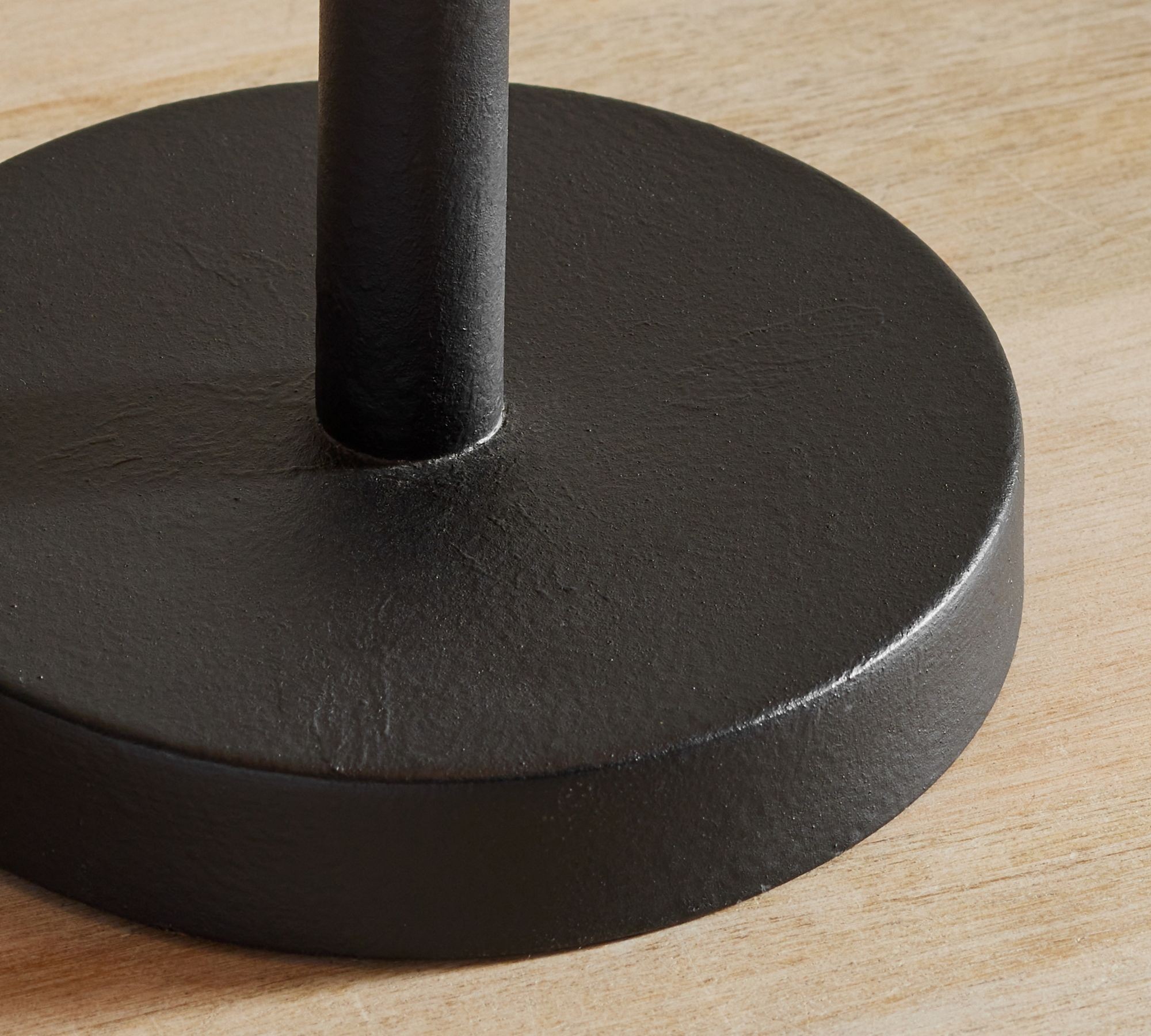 Close-up of the black round base and metal stem finish