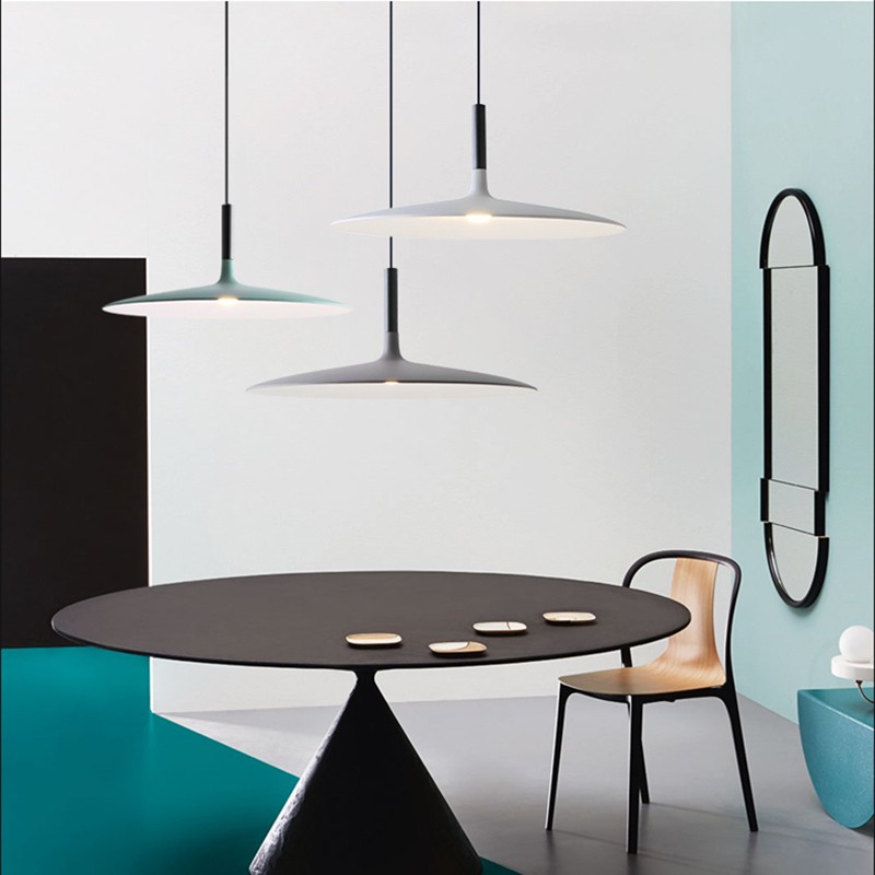 Multiple Scandinavian cone pendant lights over a table