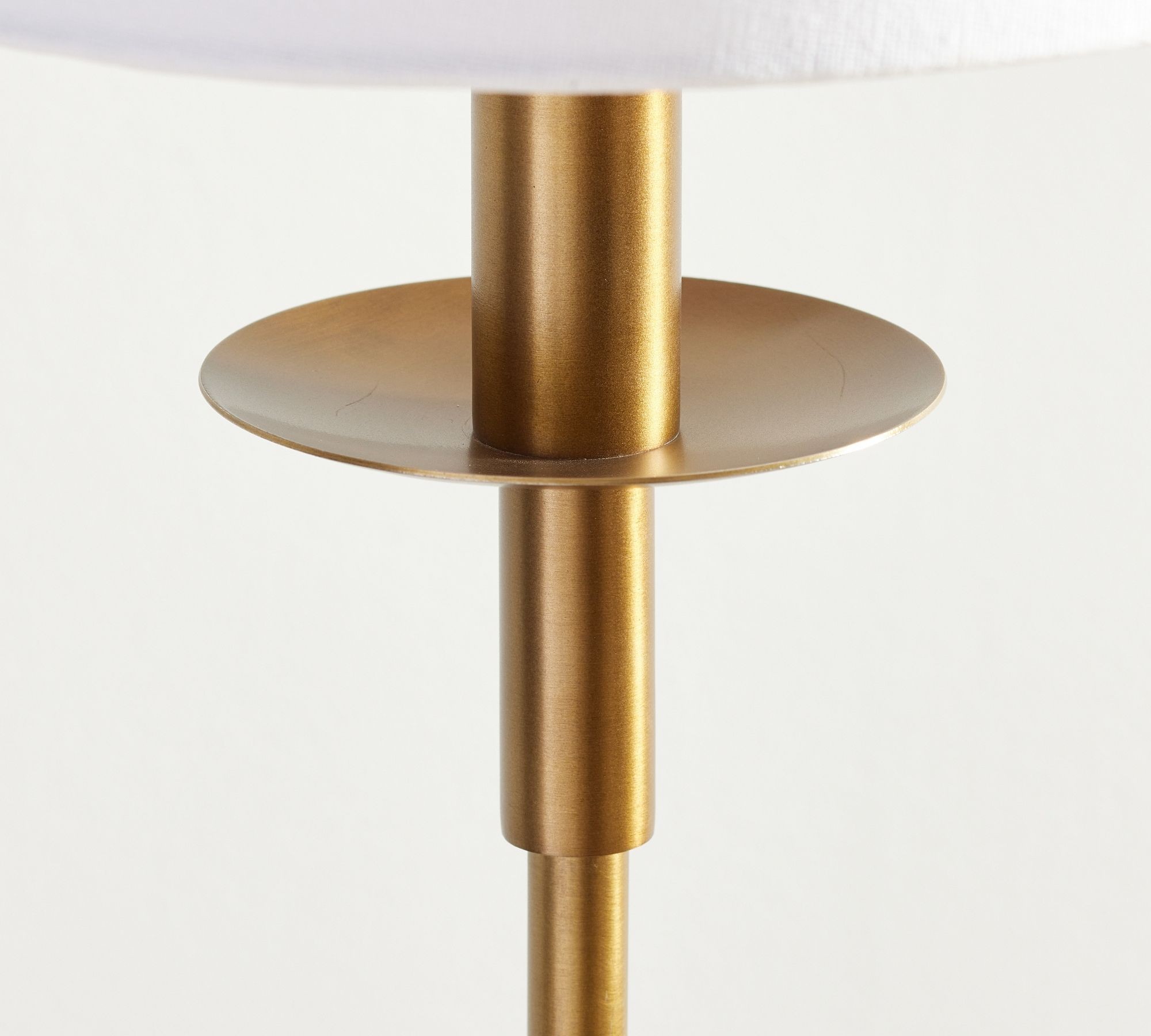 Close-up of brass finish stem and shade support on the Rowan table lamp