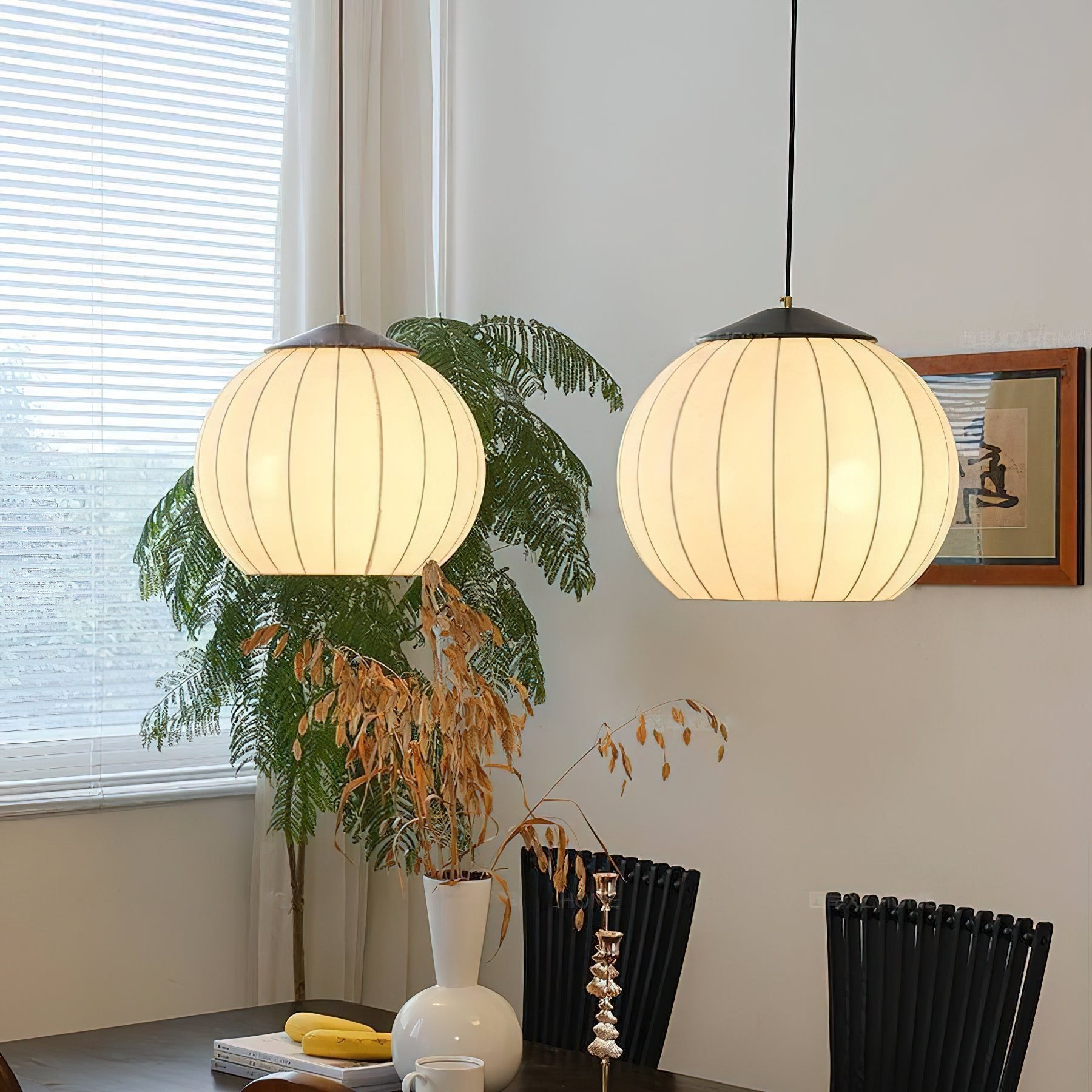 Two matching Japanese fabric lantern pendant lamps installed together
