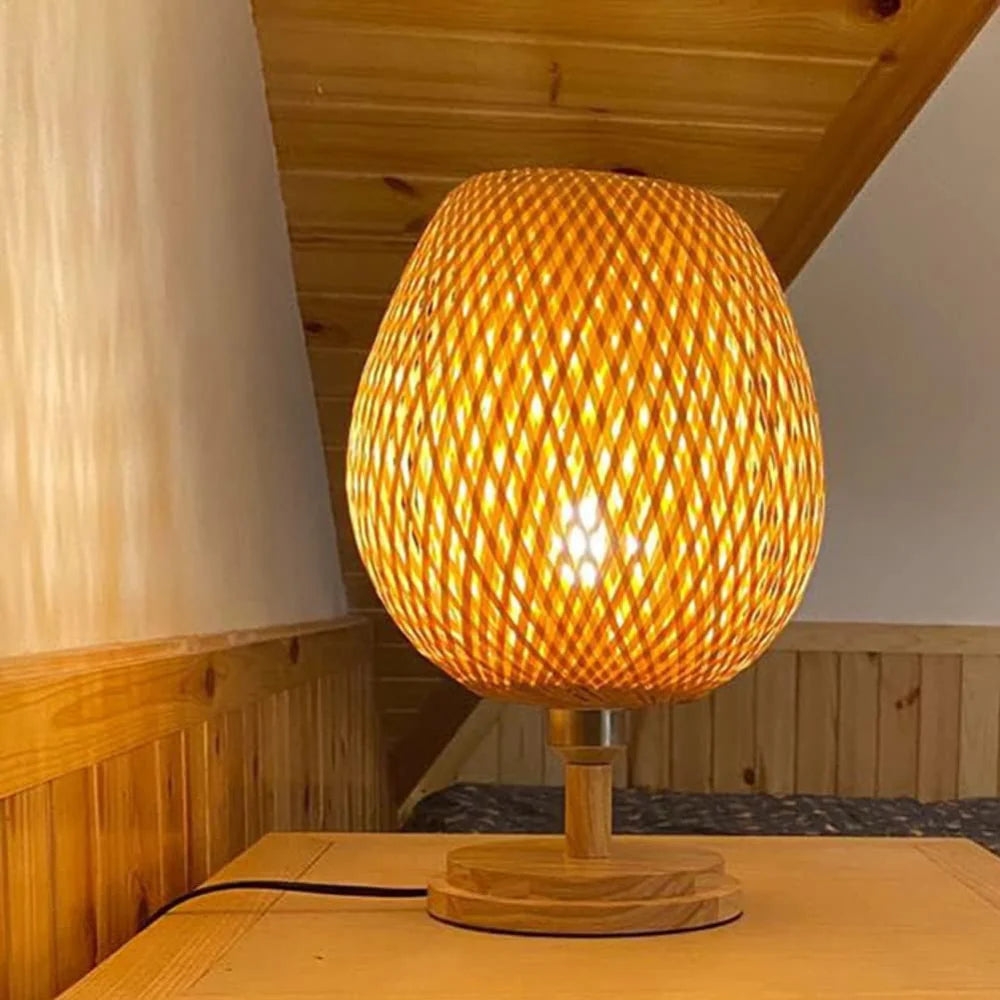 Lit round bamboo lamp on bedside or side table