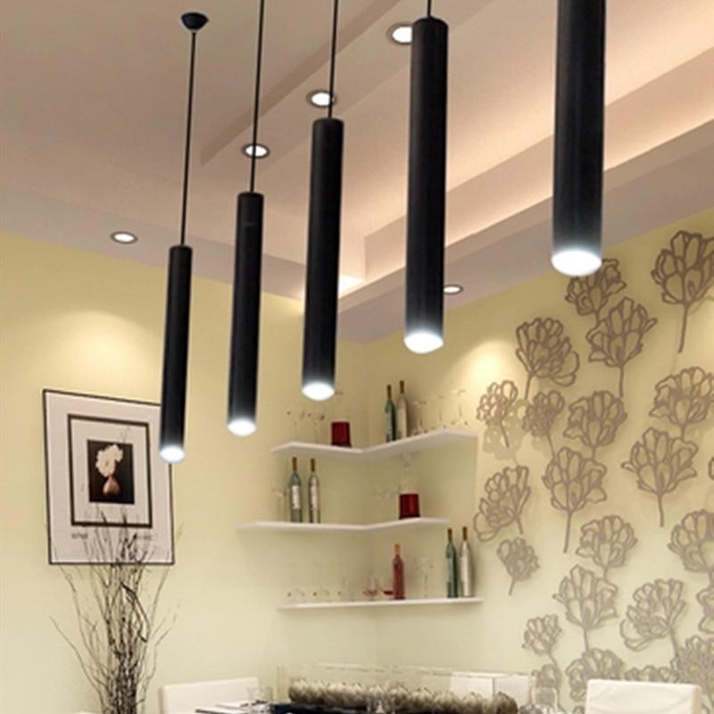 Close room view of illuminated tubular pendants