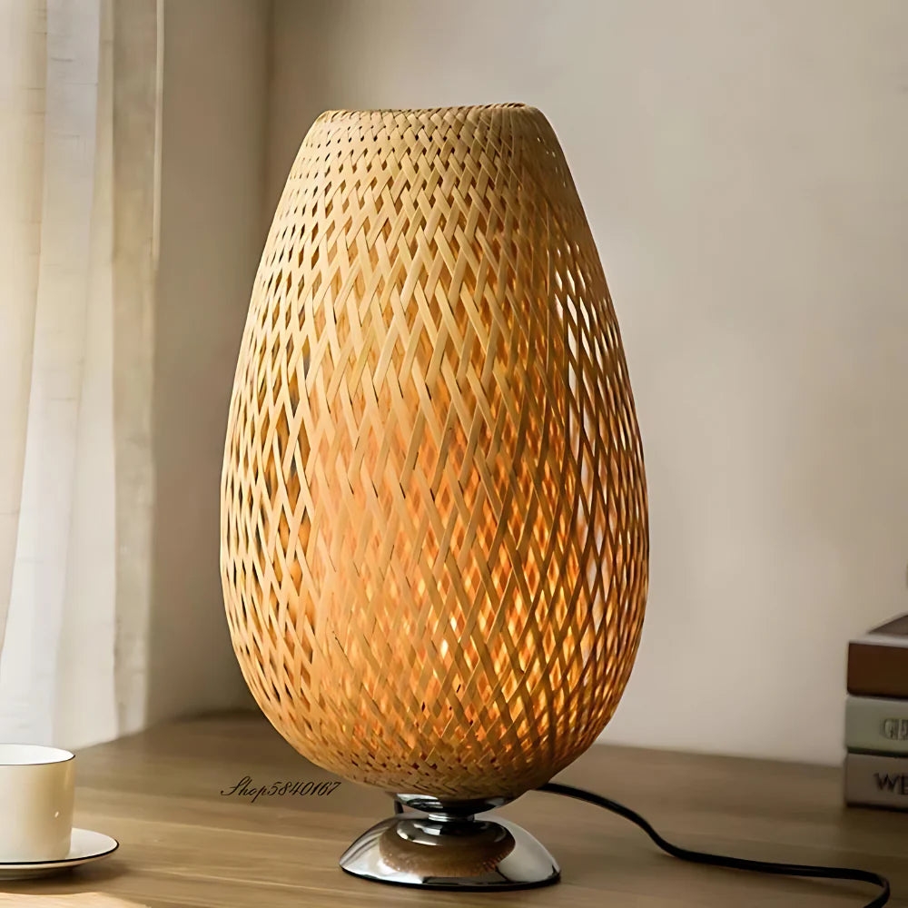 Close lifestyle view of bamboo lamp on a desk with power cord visible