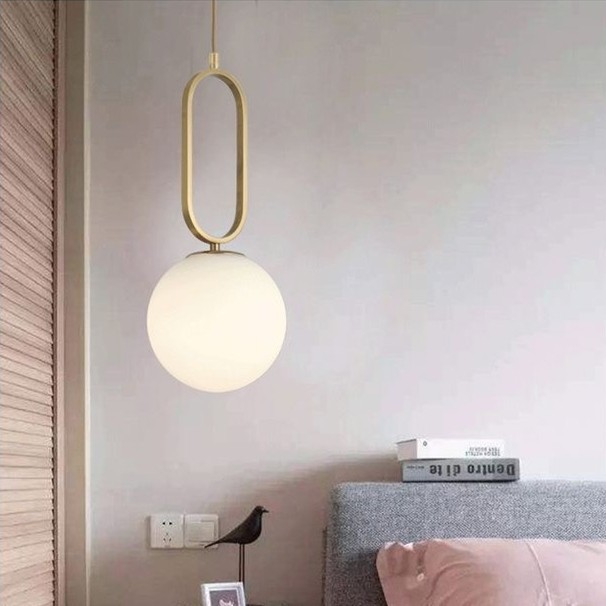 Oval ring pendant light installed beside a bed