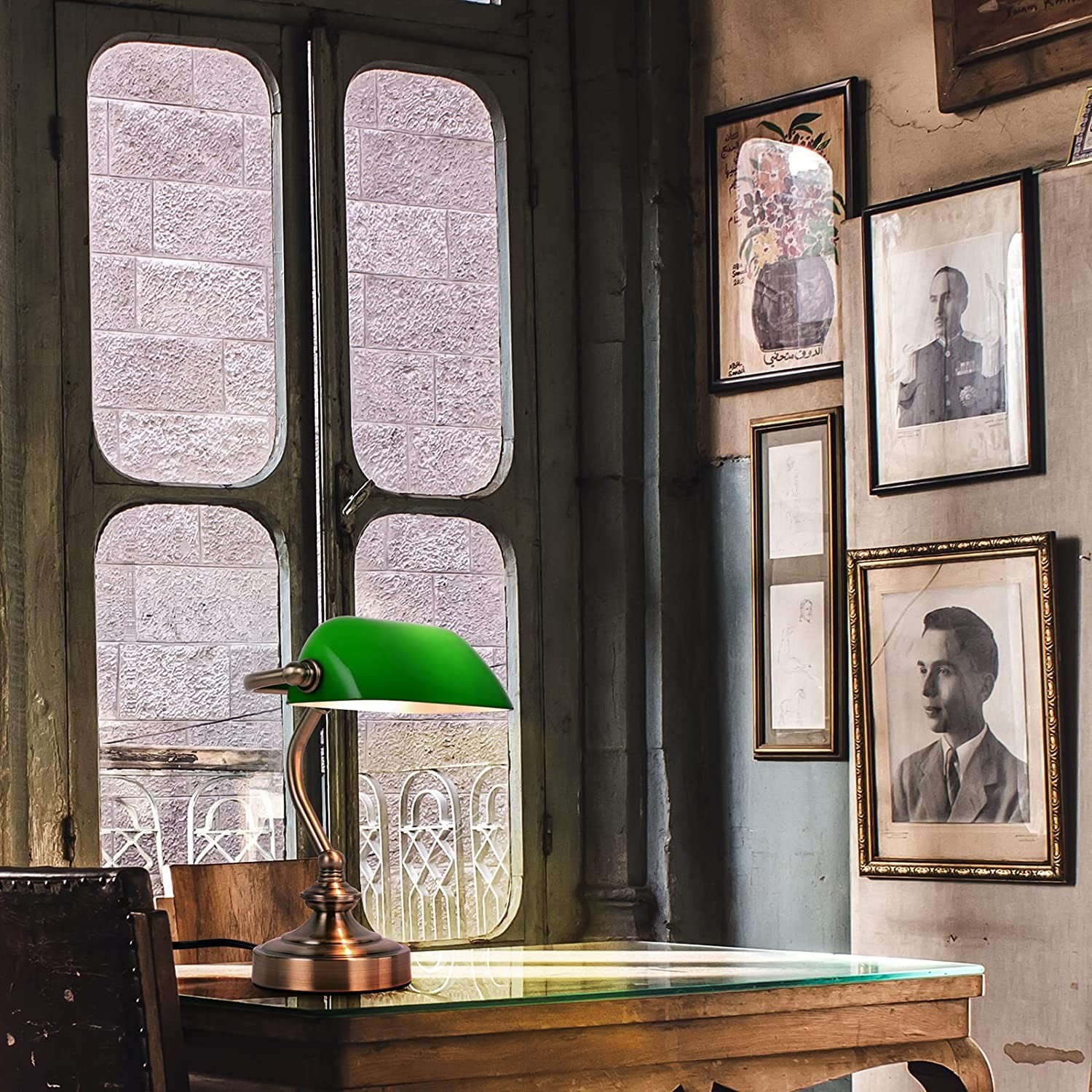 Green banker lamp in a library study interior