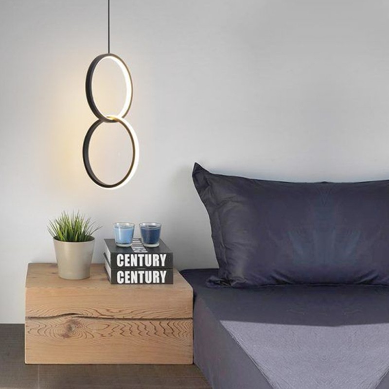 Double ring pendant beside a bed and nightstand