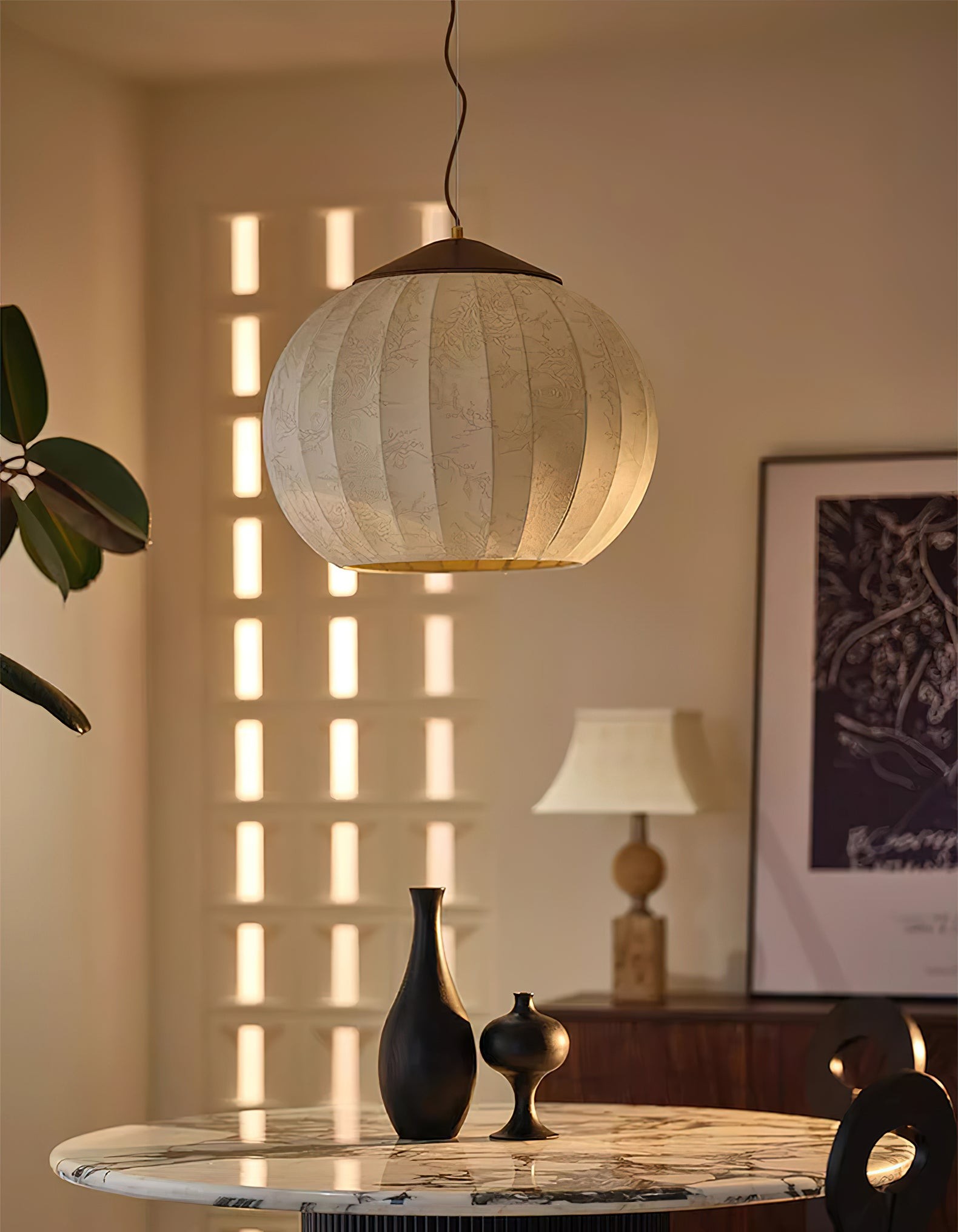 Close lifestyle view of fabric lantern pendant over a tabletop