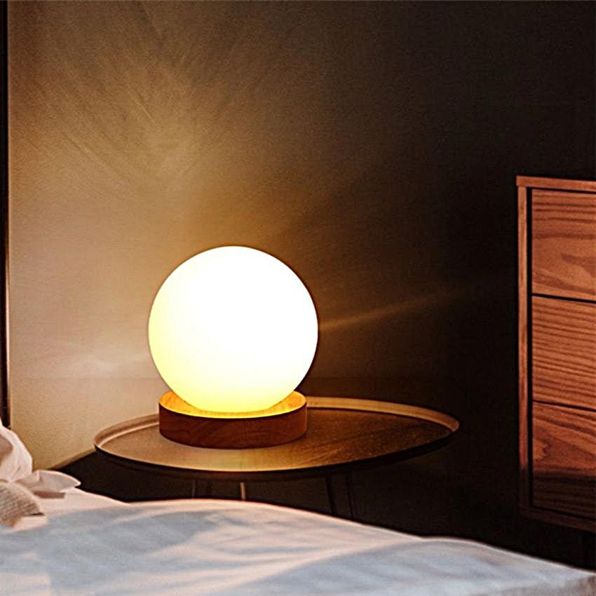 Spherical COZY LED Table Light in a dark bedroom scene