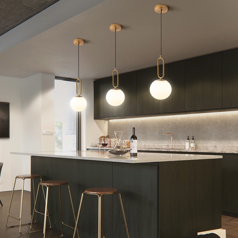 Oval ring pendant lights installed over a kitchen island
