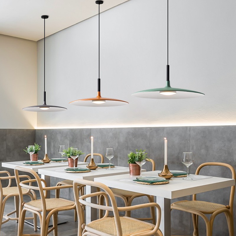 Three cone pendant color variants installed above a dining table