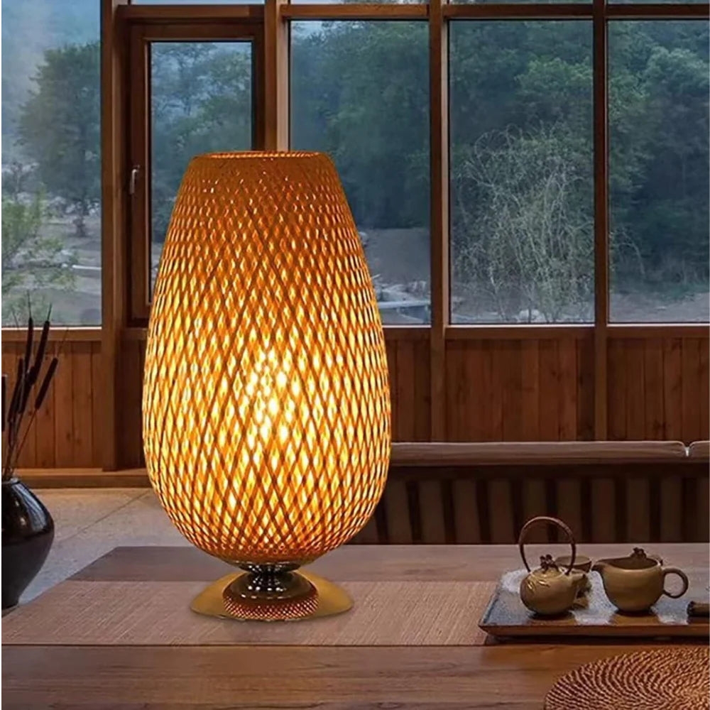 Bamboo lamp glowing on a rustic table with tea props