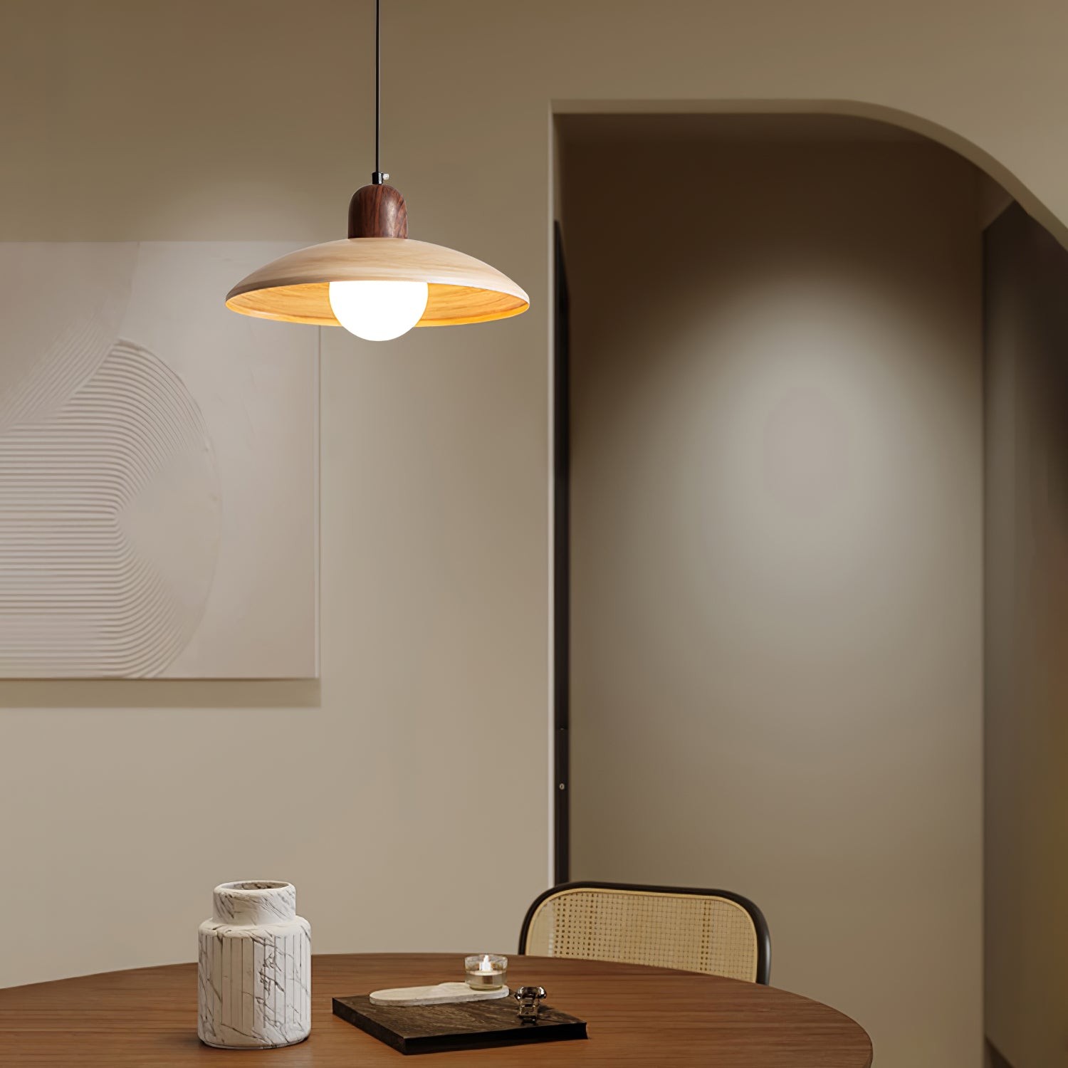Pendant lamp lit above a table in an interior room