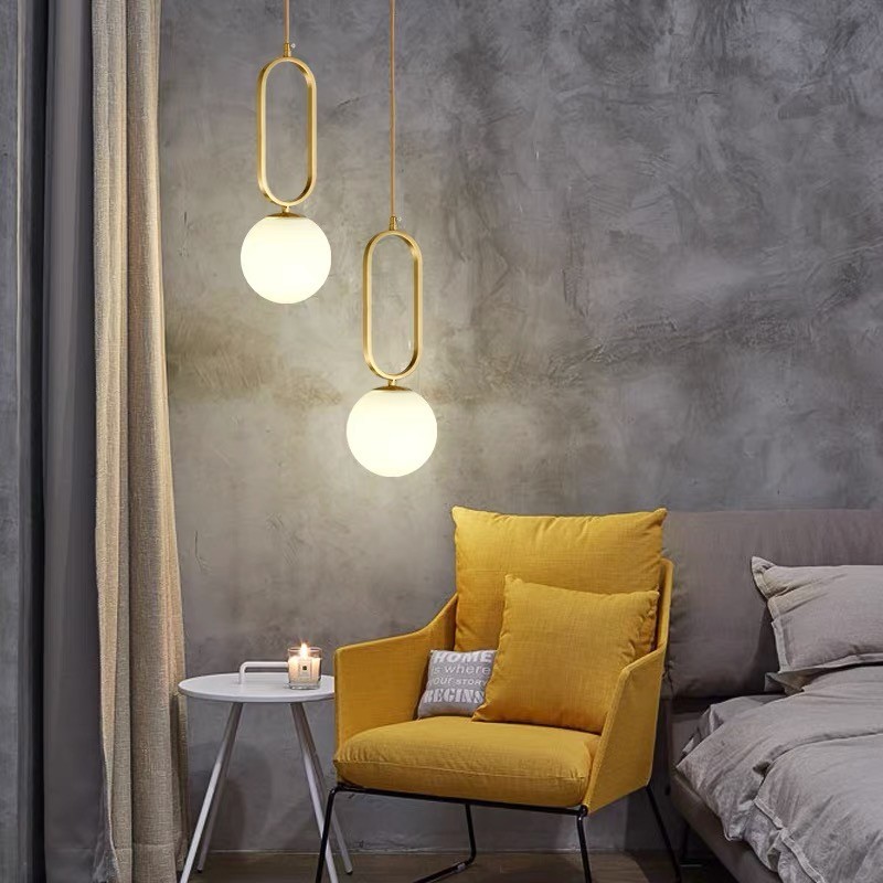Two oval ring pendant lights in a bedroom lounge setting
