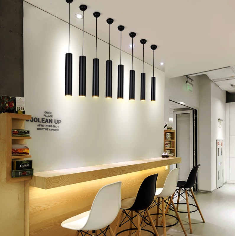 Tubular pendant lamps in a cafe seating area
