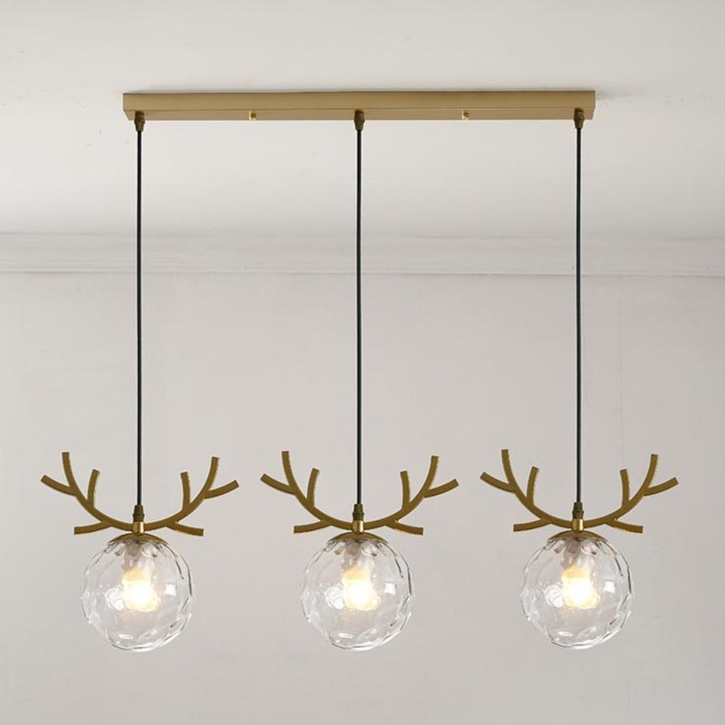 Złota lampa wisząca WARM z przezroczystym szkłem