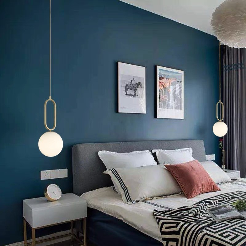 Bedroom scene with pendant lights on both sides of a bed
