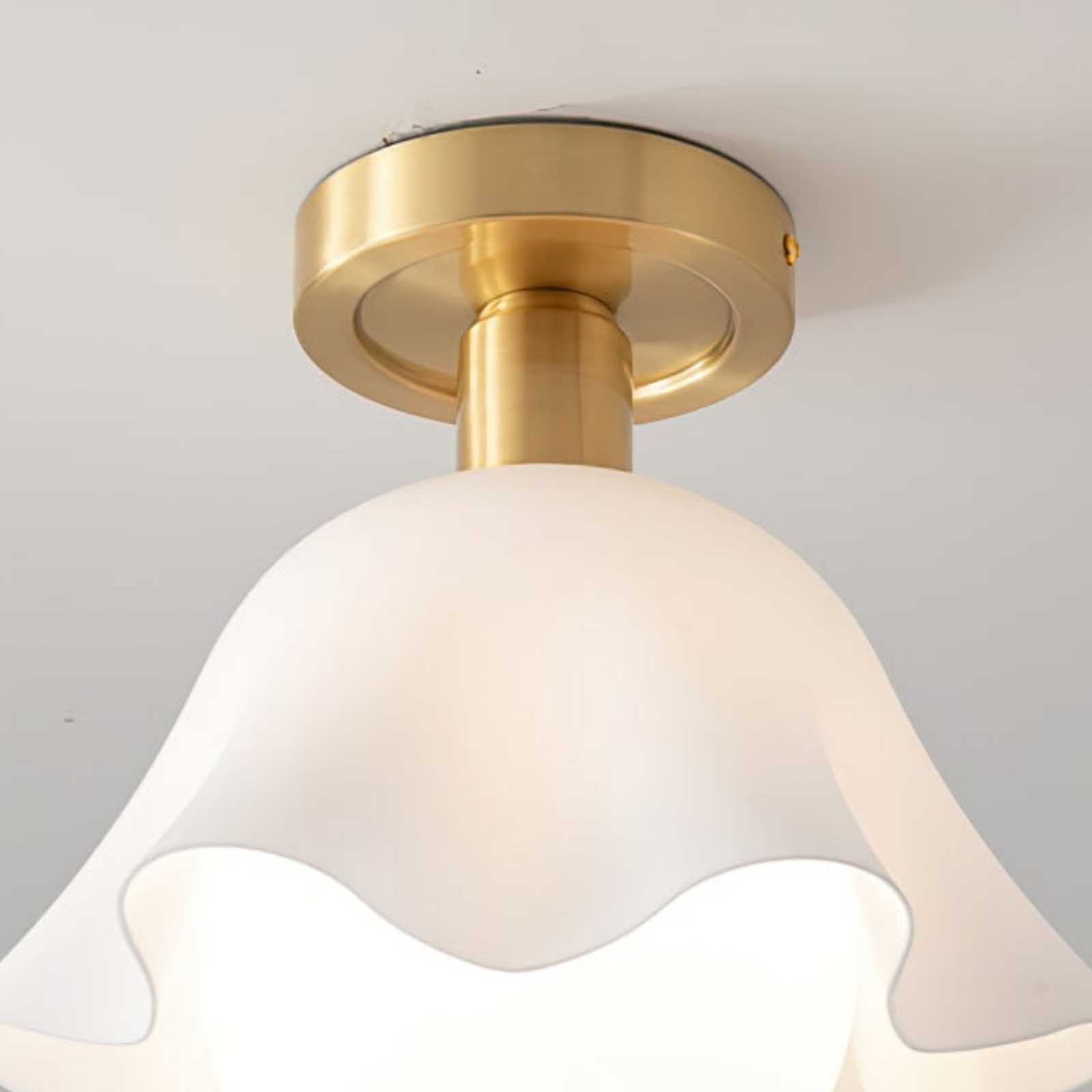 Detail of brass stem and flower-shaped glass shade on French Flower Ceiling Light