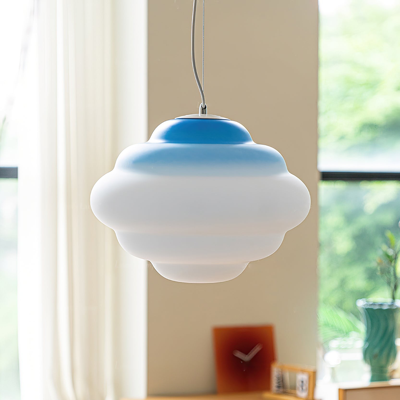 Closer blue gradient pendant lamp in a window setting