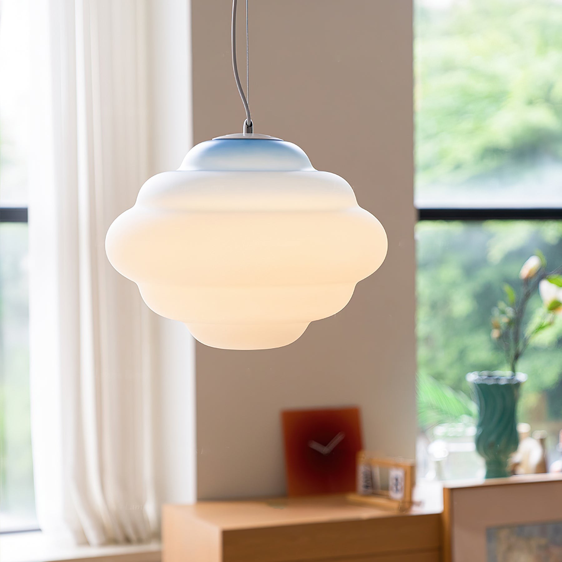Blue gradient pendant lamp by a bright window